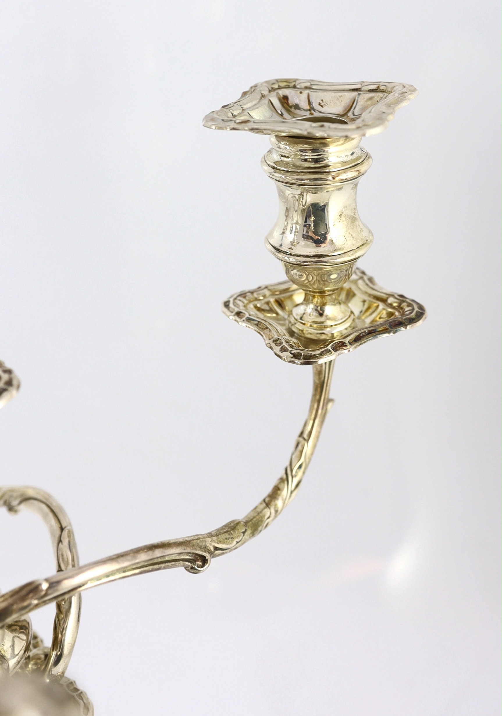 A good pair of George V silver four branch five light candelabra, by Elkington & Co.